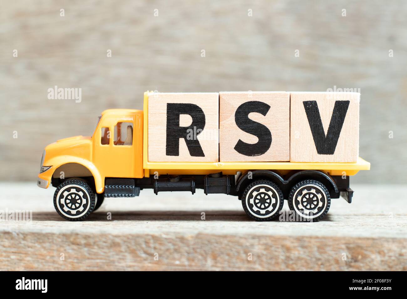 Spielzeug LKW halten Alphabet Buchstaben Block im Wort RSV (Respiratorische Synzytialvirus) auf Holzhintergrund Stockfoto