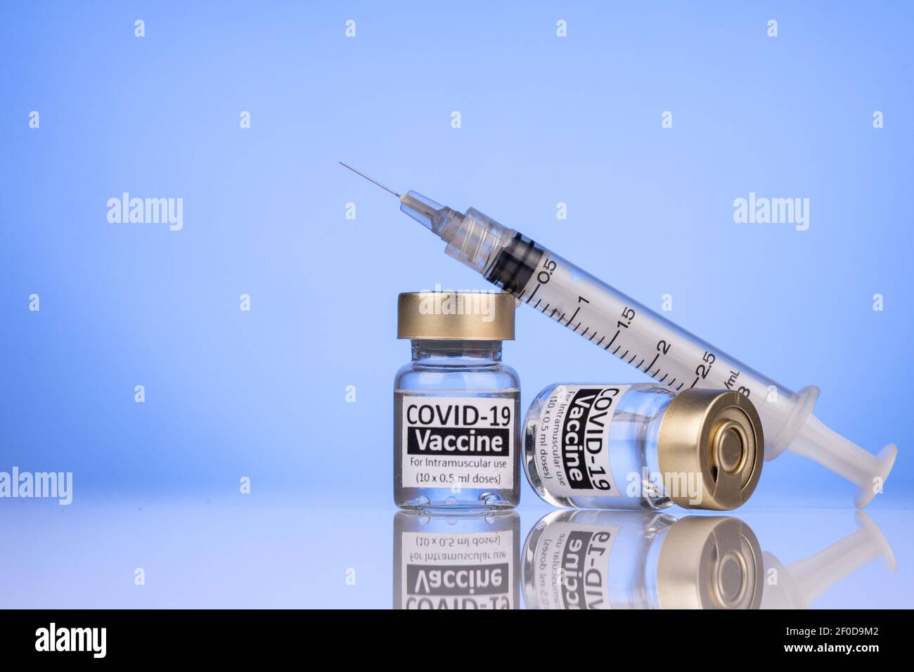 Spritze auf Covid-19 Impfstofffläschchen Konzept mit reflektierender Oberfläche Stockfoto