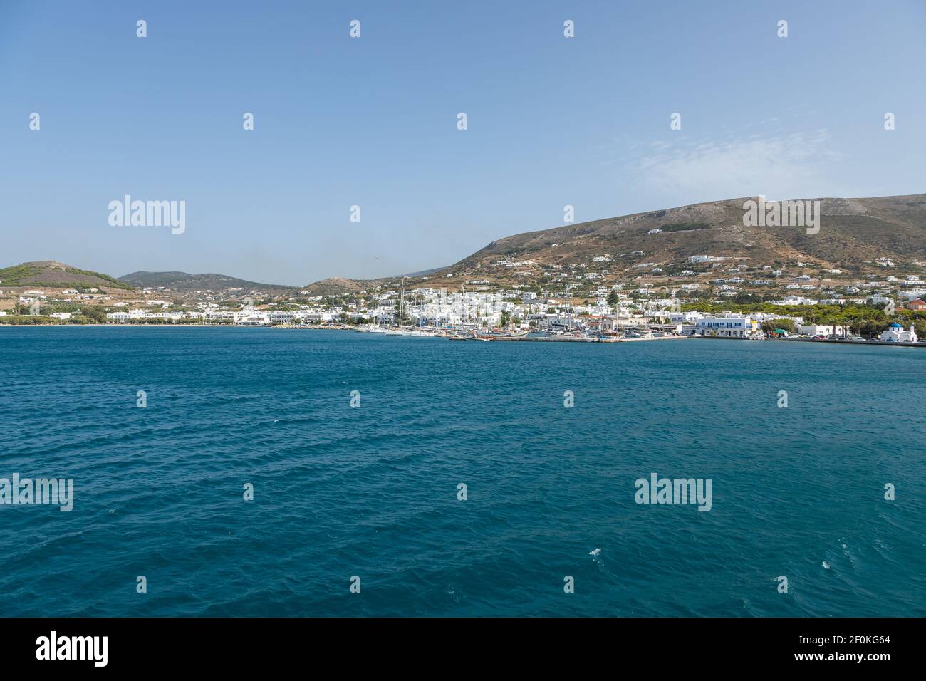 Paros Insel, Griechenland - 26. September 2020: Blick auf den Hafen mit traditionellen Gebäuden auf den Hügeln im Hintergrund. Stockfoto