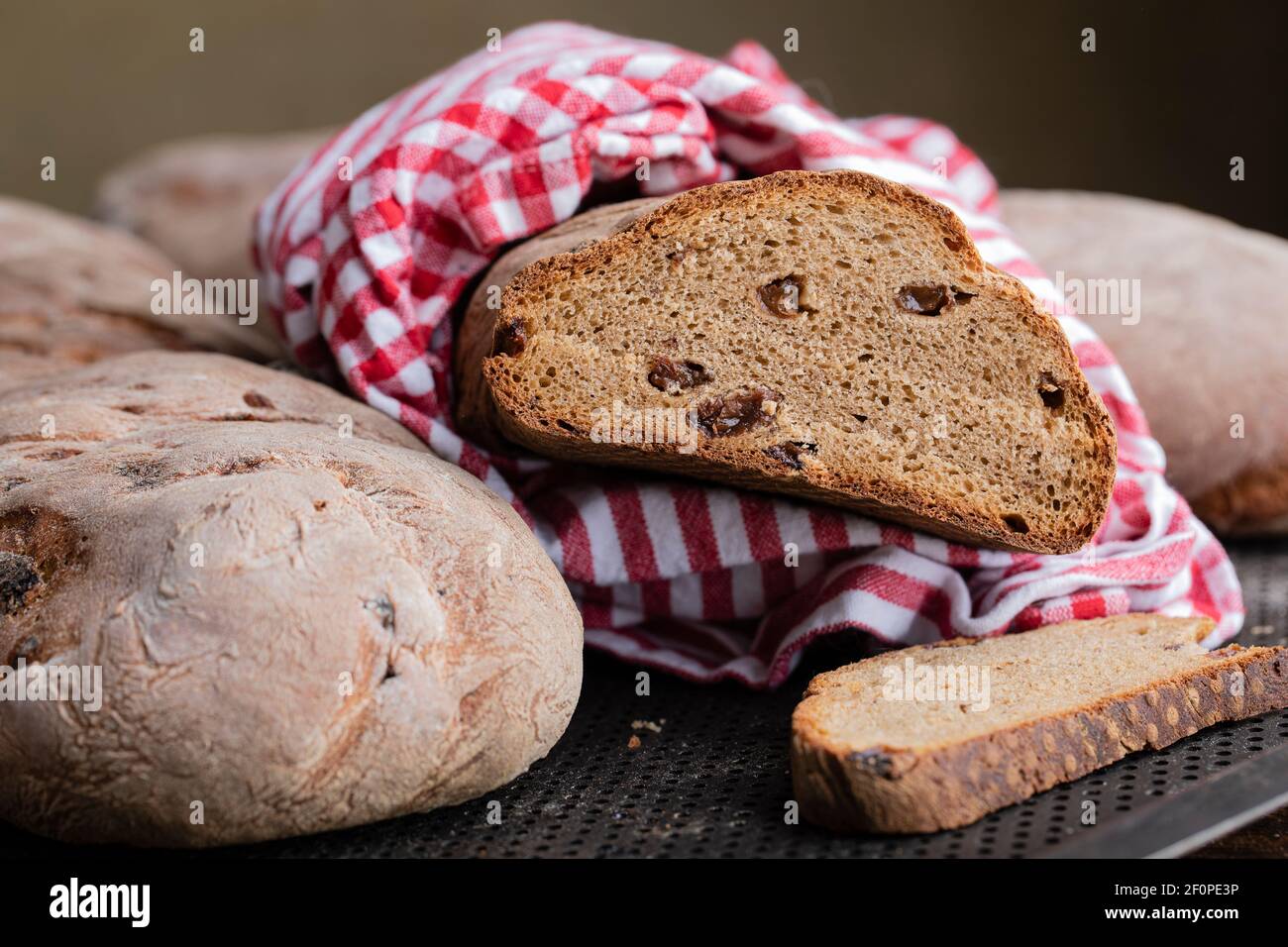 Braunes Brot mit Rosinen, Querschnitt und Vollbrot. Dieses traditionelle schwedische weihnachtsbrot wird mit Bier und schwedischem Julmust-Soda-Getränk hergestellt. Cl Stockfoto