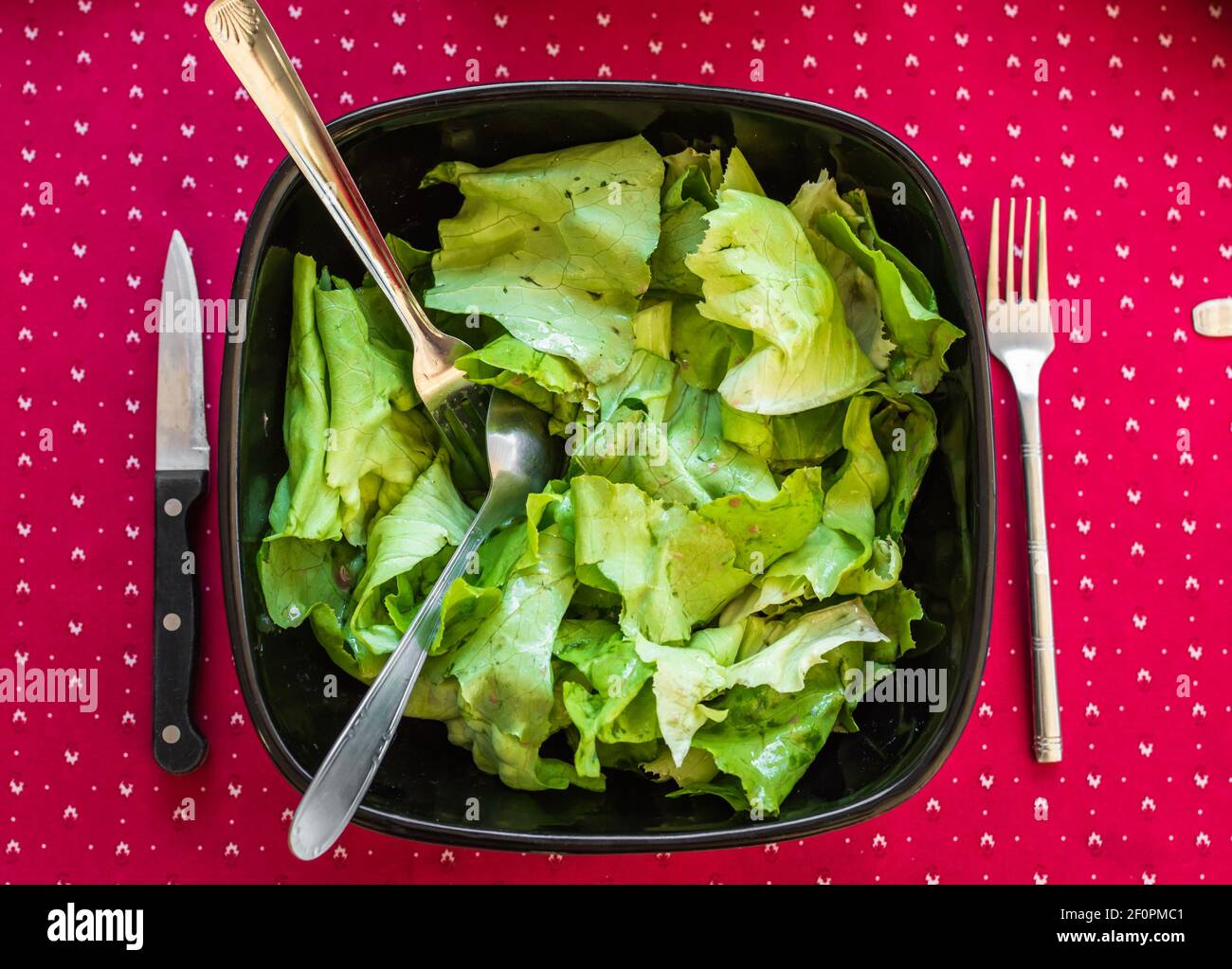 Salat in schwarzer Schüssel Stockfoto