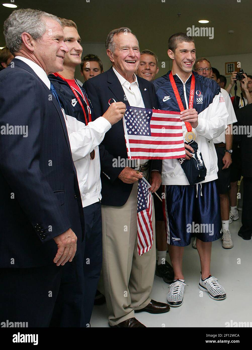 Präsident George W. Bush und ehemaliger Präsident George H.W. Bush posiert für Fotos mit den US-Olympiaschwimmern Larsen Jensen Left und Michael Phelps Sonntag 10 2008. August im National Aquatics Center in Peking. Stockfoto