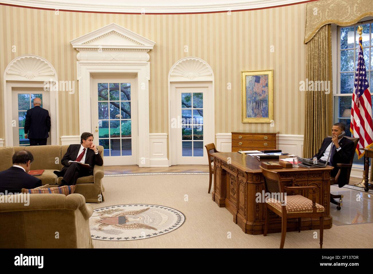 Präsident Barack Obama spricht am Telefon, während Vizepräsident Joe Biden sein nationaler Sicherheitsberater Tony Blinken und Puneet Talwar Senior Director für den Irak Iran und die Golfstaaten in der Nähe im Oval Office warten 4 2010. November. Stockfoto