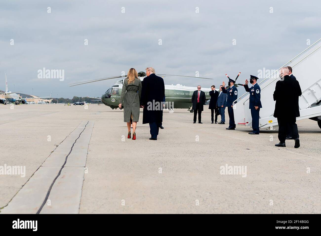 Präsident Donald Trump und First Lady Melania Trump gehen über den Asphalt, nachdem sie mit Reportern gesprochen haben Dienstag, 27 2020. Oktober, in der Joint Base Andrews MD Stockfoto