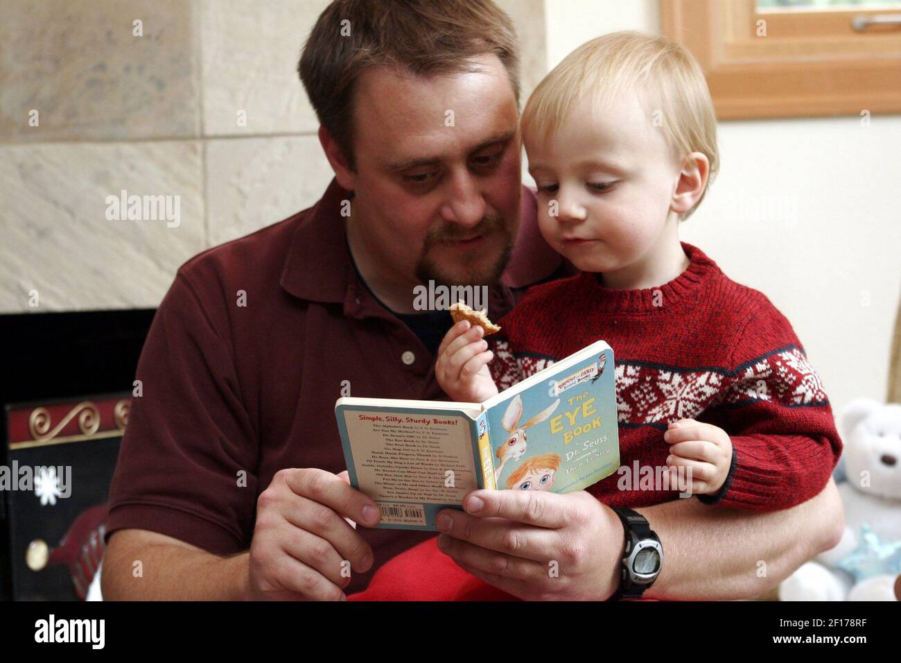 Chris Yeargin und sein zwei Jahre alter Sohn Ethan lasen ein Buch und aßen einen Snack, kurz nachdem Chris von der Arbeit nach Hause kam. Chris hat sowohl den Job als auch den Lebensstil geändert, so dass er mehr in das Leben seines Sohnes auf einer täglichen Basis einbezogen werden könnte. (Foto von Thomas James Hurst/Seattle Times/KRT) Stockfoto