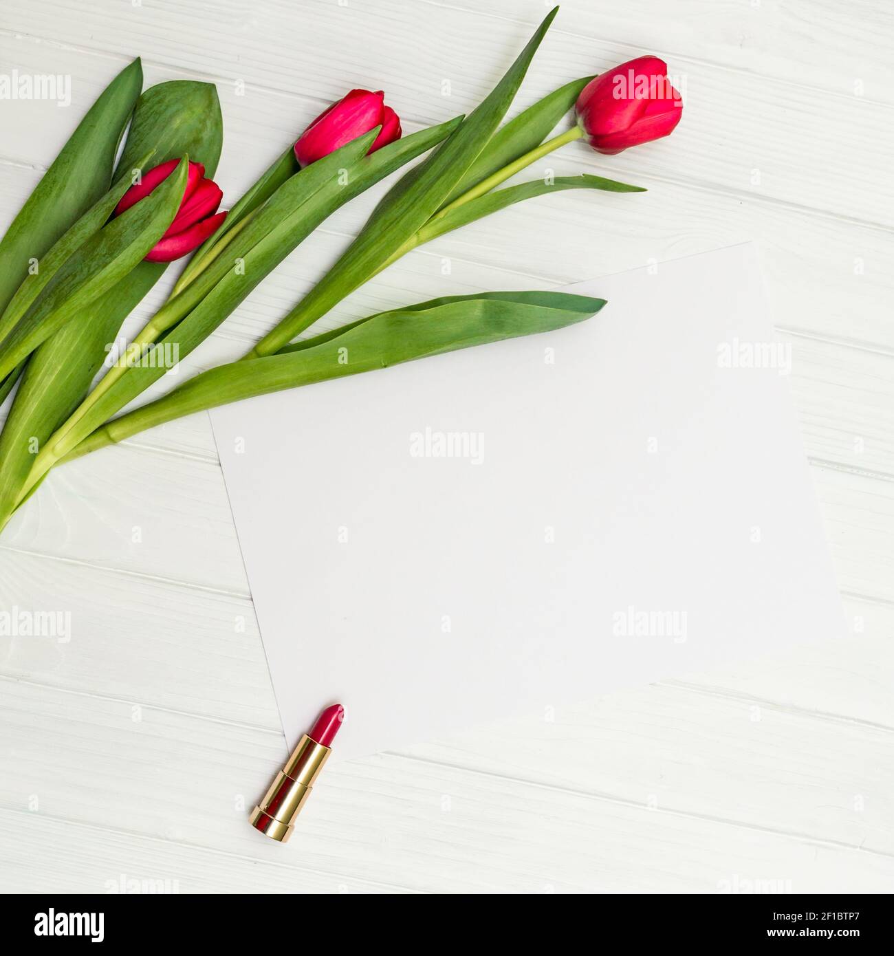 Rote Tulpen auf einem weißen Holzbrett Stockfoto