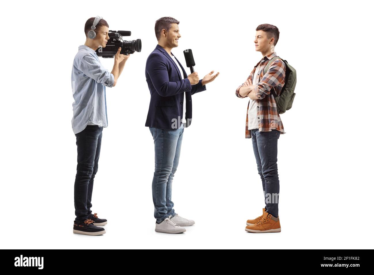 In voller Länge Profilaufnahme eines Reporters mit einem Mikrofon Und ein Kameramann interviewte einen männlichen Schüler isoliert auf weiß Hintergrund Stockfoto