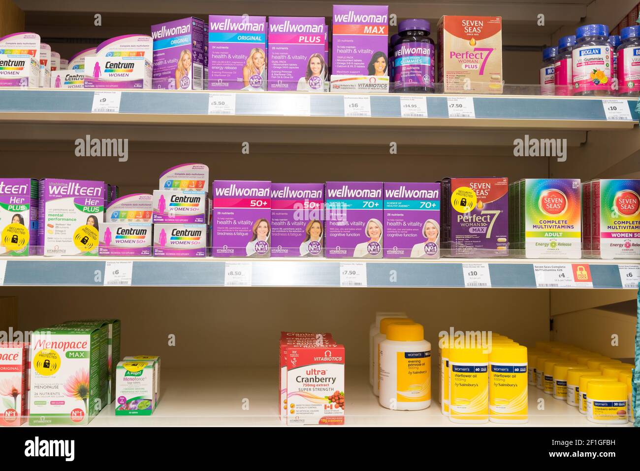 Komplementärmedizin von Multivitamine-Tabletten in Kartons und Flaschen in Regalen zum Verkauf in Sainsbury's Supermarkt, England Stockfoto
