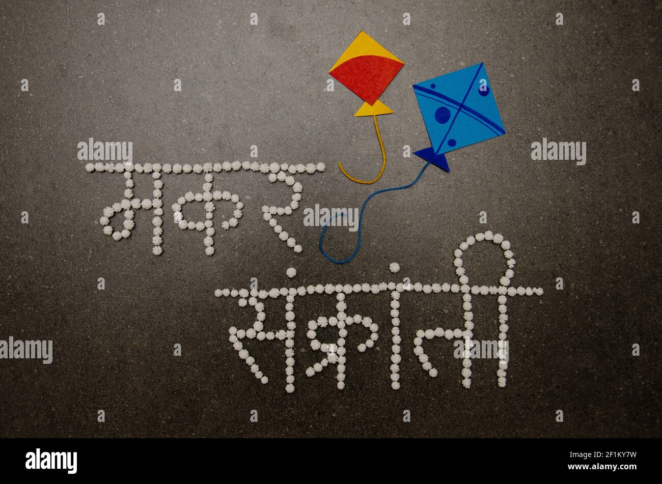 Makar Sankranti Typografie in Devanagari Schrift mit weißer Halwa Oder Zuckerbällchen Stockfoto