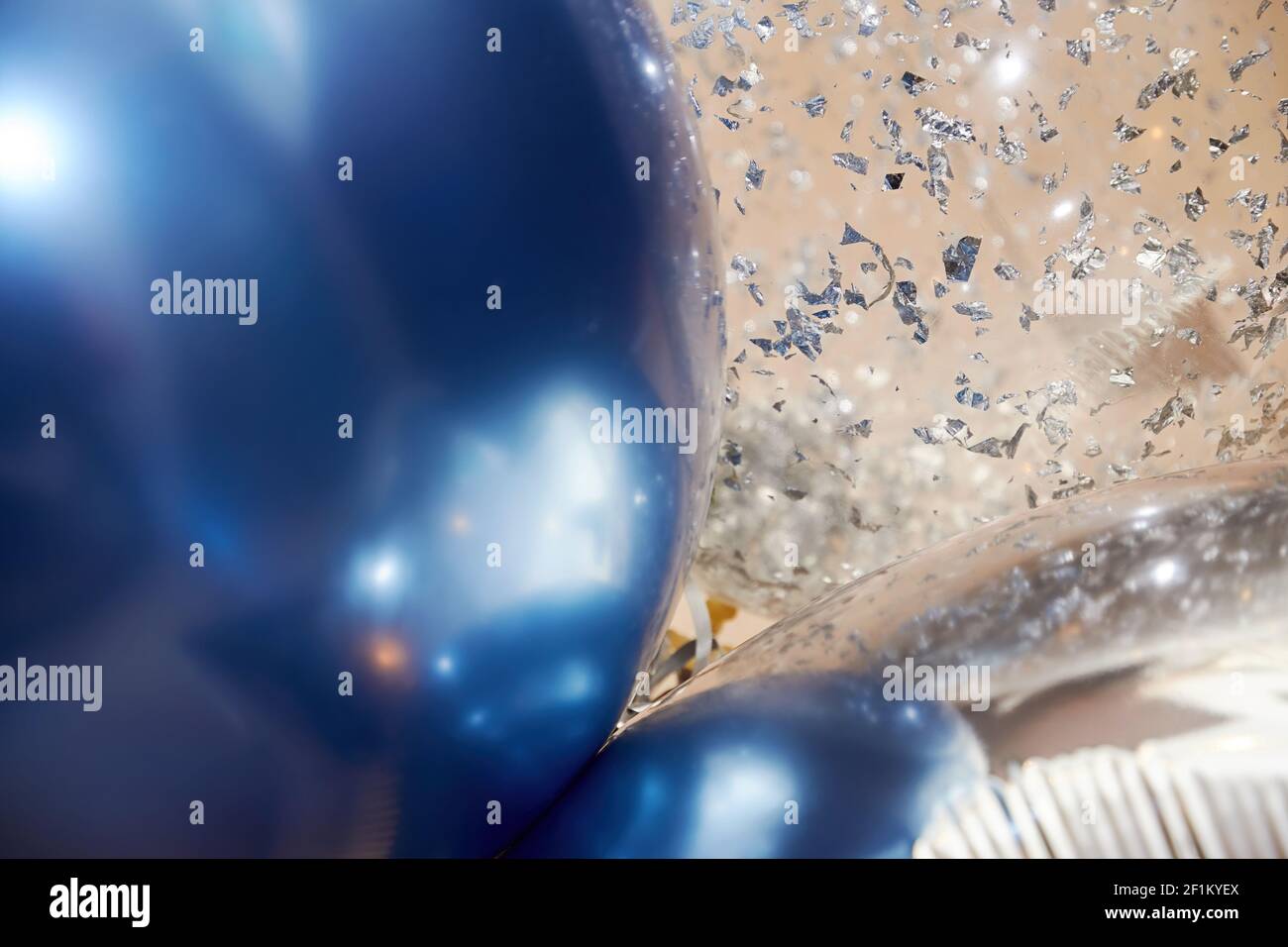 Blaue, silberne und transparente, reich verzierte Heliumballons auf dem festlichen Event. Feier Symbole und Hintergründe Stockfoto