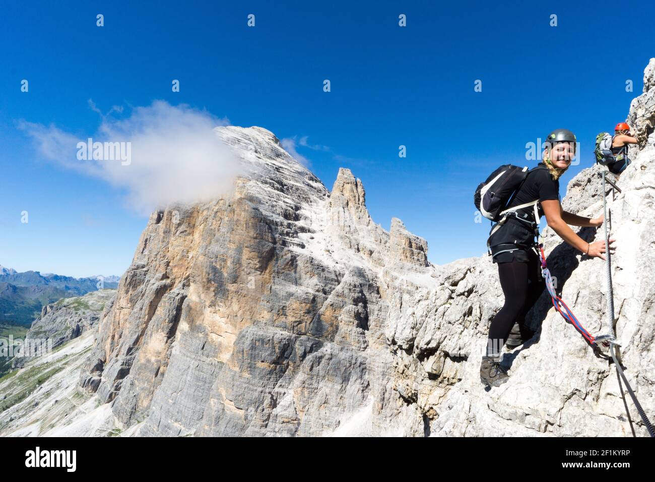 Junge attraktive blonde Bergsteigerin in den Dolomiten Italien Stockfoto