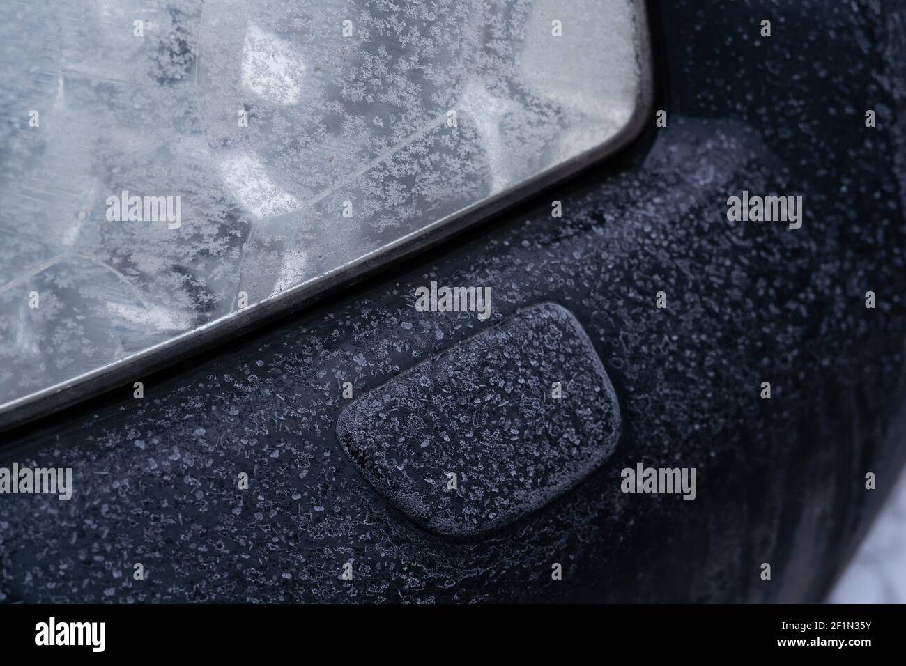 Der Mechanismus der Scheinwerferwaschanlage im Fahrzeug ist mit abgedeckt Frost am Morgen Stockfoto