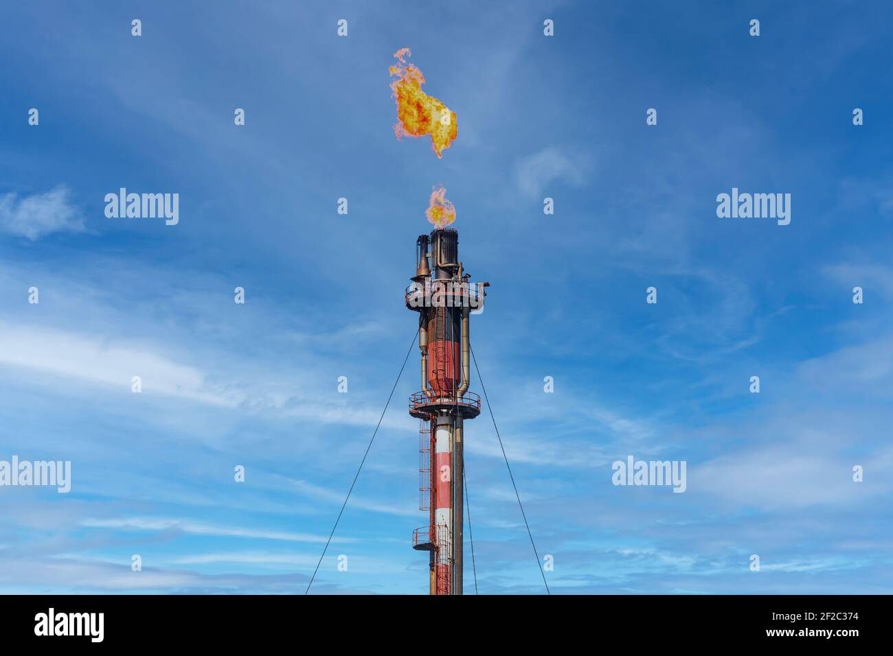 Abgaskamin der petrochemischen Industrie mit brennender Flamme von Palos de la Frontera in Huelva, Andalusien, Spanien. Stockfoto