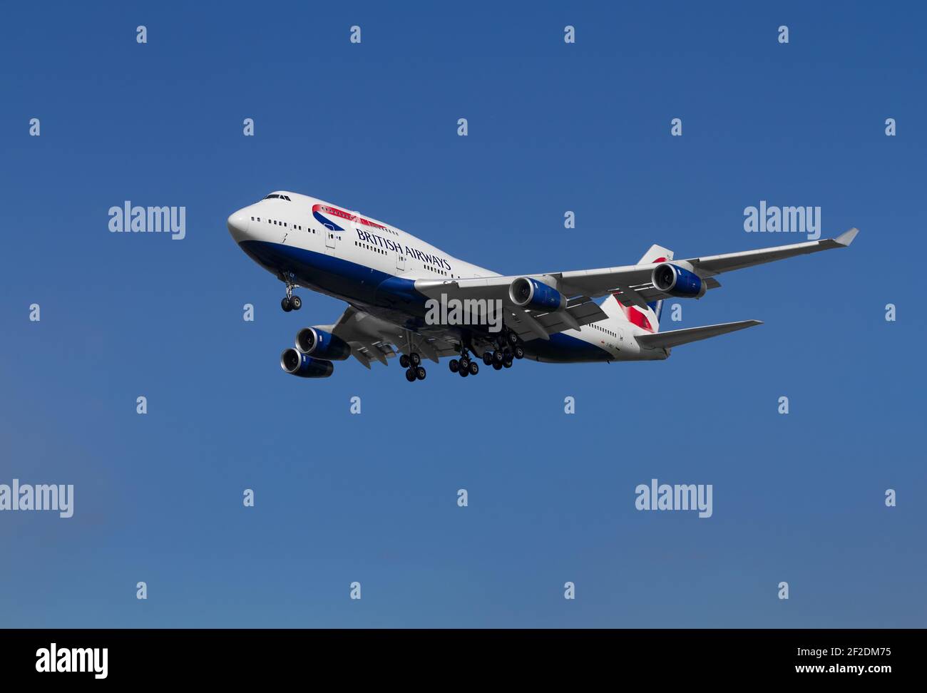 Großbritannien, London - Mai 2015: British Airways, pensionierte Boeing 747 fliegen durch einen klaren blauen Himmel mit seinem Fahrwerk nach unten und Schlange für die Start-und Landebahn. Ima Stockfoto