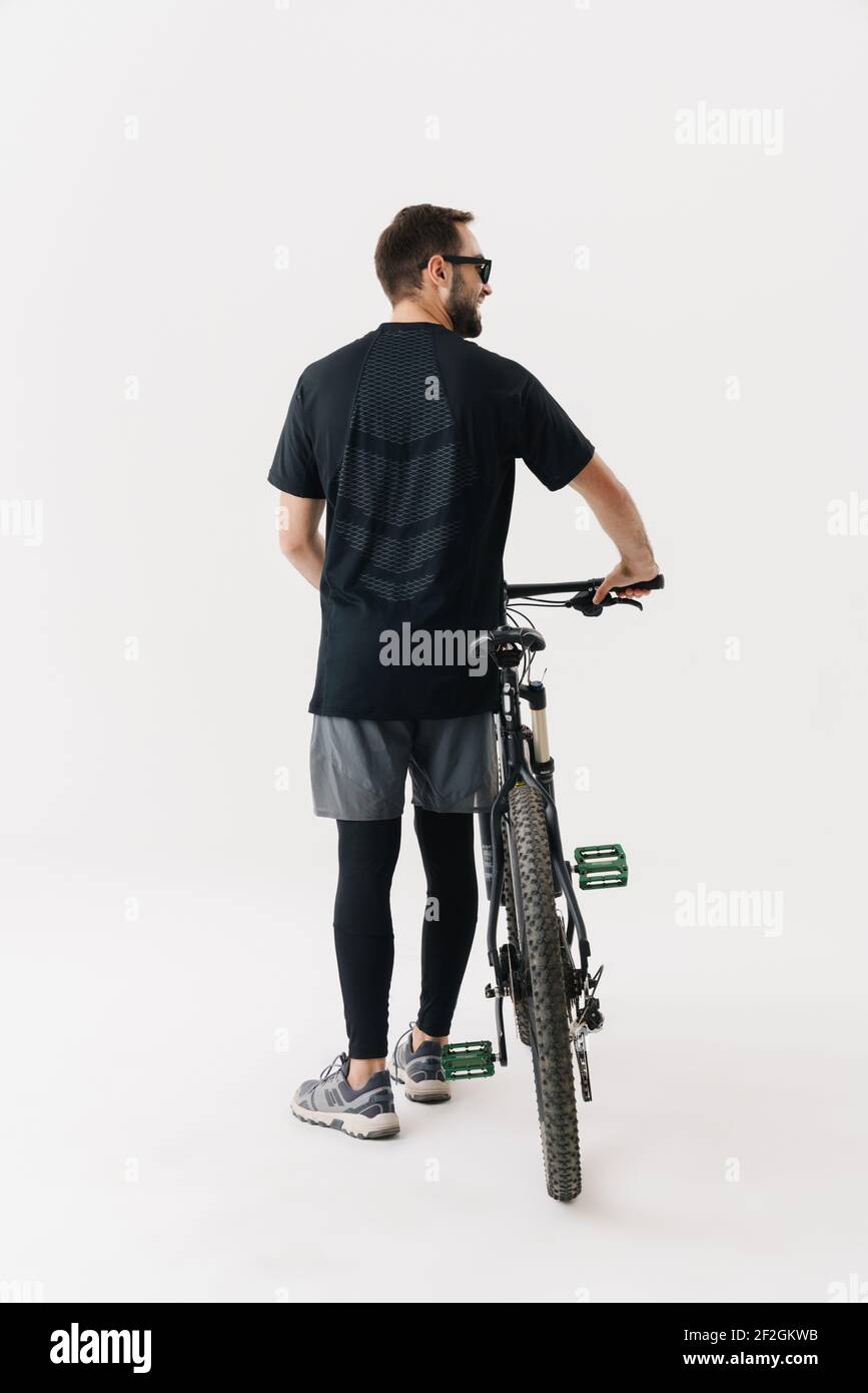 Glücklicher Radfahrer Sportler mit einem Fahrrad isoliert auf weißem Hintergrund Stockfoto
