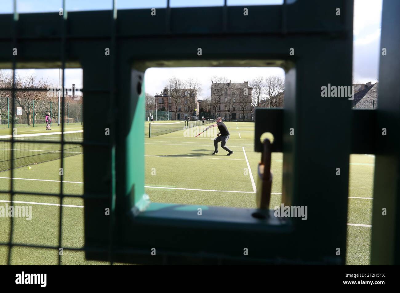 Eine Person spielt Tennis im Kelvingrove Tennisclub in Glasgow, da Outdoor-Sportarten ohne Kontakt nach der Lockerung einiger Einschränkungen in Schottland wieder aufgenommen werden können. Bilddatum: Freitag, 12. März 2021. Stockfoto