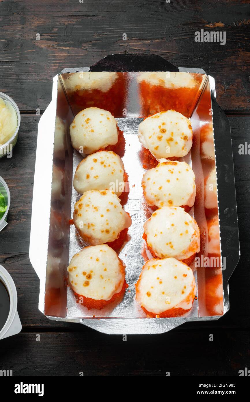 Set von Sushi-Rollen in Lieferung Food-Box-Set, auf alten dunklen Holztisch Hintergrund Stockfoto