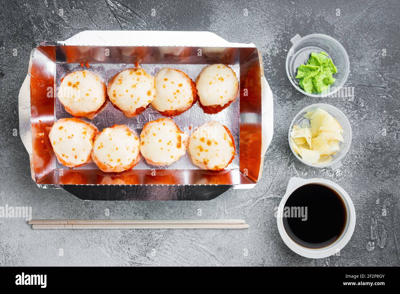 Sushi Roll Delivery Set, auf grauem Steingrund, Draufsicht flach liegend Stockfoto