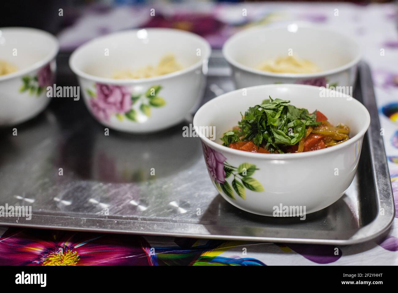 Abendessen mit einer lokalen uigurischen Familie in der Stadt Karakol im kirgisischen Issyk Kol Gebiet. Stockfoto