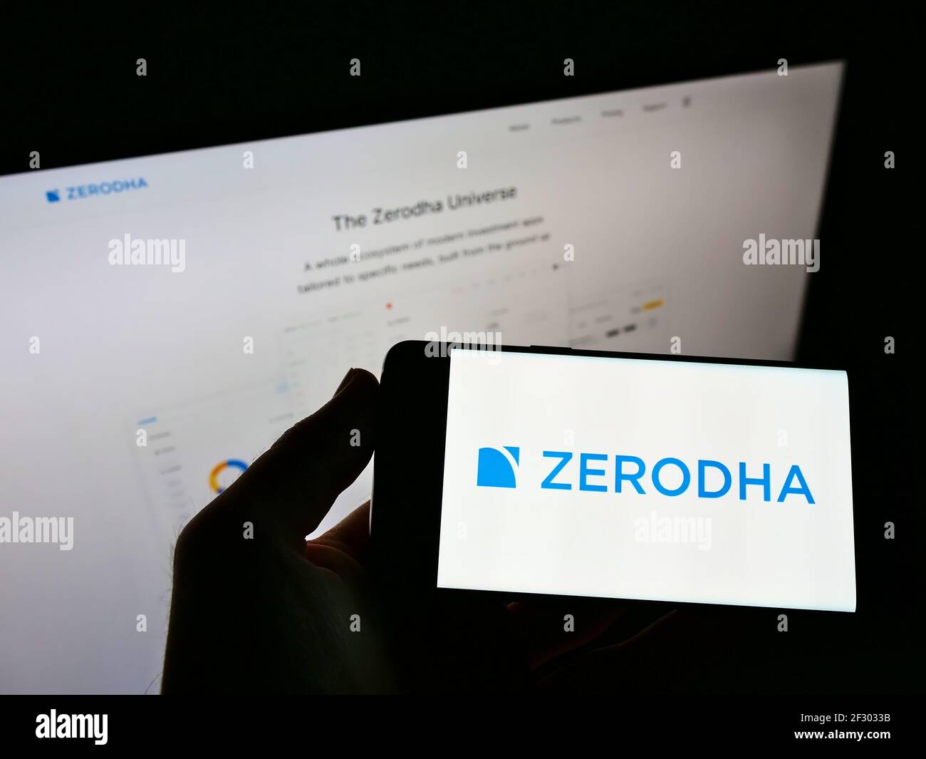 Person hält Handy mit Logo der indischen Finanzdienstleister Zerodha Broking Ltd. Auf dem Bildschirm vor der Webseite. Konzentrieren Sie sich auf die Telefonanzeige. Stockfoto