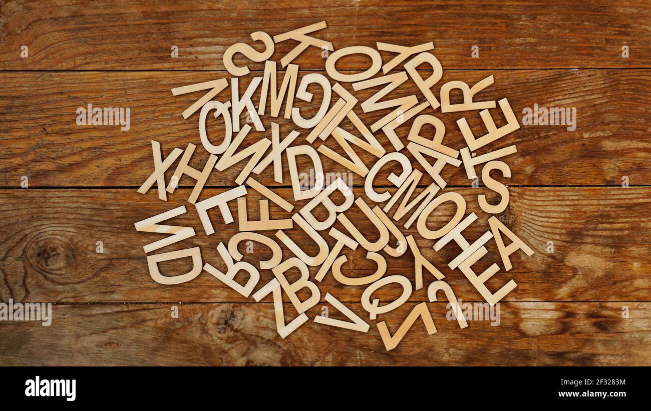 Holzbuchstaben auf Holzhintergrund. Die Buchstaben des englischen Alphabets. Stockfoto
