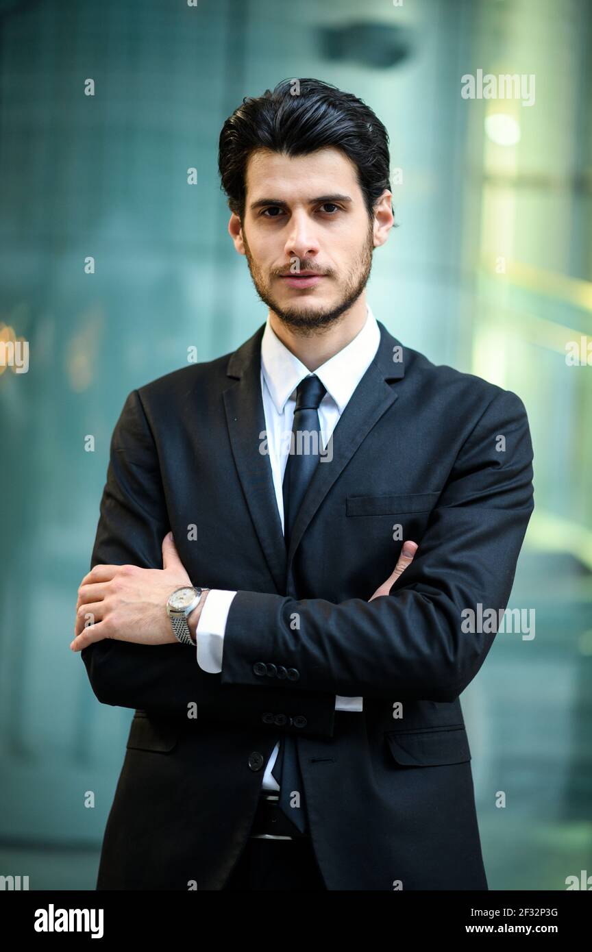 Junger Geschäftsmann im Freien lächelt selbstbewusst Stockfoto