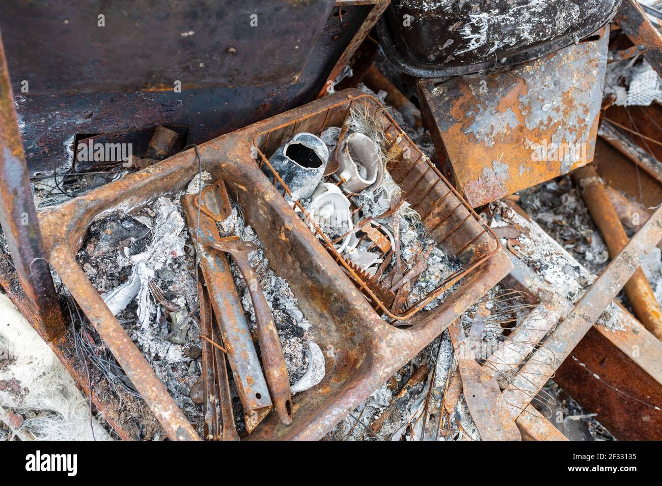 Ein rostiger Küchenspüle, der von einem ausgebrannten Wohnmobil übrig blieb Stockfoto