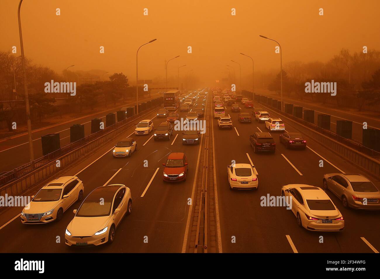 Peking, China. März 2021, 15th. Der Verkehr macht seinen Weg entlang einer Schnellstraße, die von einem dicken Sandsturm umhüllt ist, in Peking am Montag, den 15. März 2021. In einigen Gebieten rund um die Hauptstadt verringerte der starke Sandsturm die Sicht auf weniger als 500 Meter und "ist auch das stärkste Staub- und Sandwetter, das China seit fast 10 Jahren trifft", so die chinesische Meteorologische Regierung. Foto von Stephen Shaver/UPI Kredit: UPI/Alamy Live Nachrichten Stockfoto