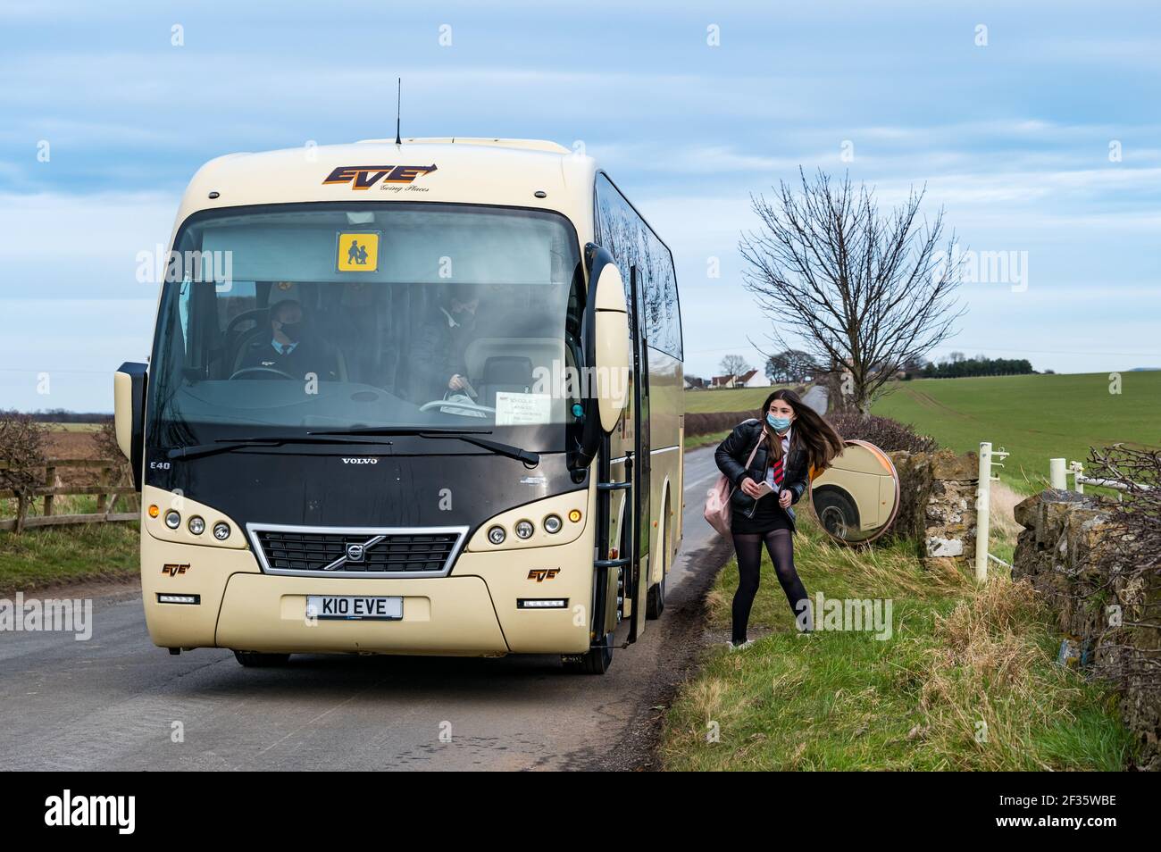 East Lothian, Schottland, Großbritannien, 15th. März 2021. Schulkinder kehren in die weiterführende Schule zurück: Die Kinder der North Berwick High School sind heute zum ersten Mal seit der kürzlichen Aussperrung während der Coronavirus-Pandemie in die Schule zurückgekehrt, aber heute nur für 3 Stunden für die ganze Woche, als sie aus dem Schulbus in Kilduff aussteigen Stockfoto