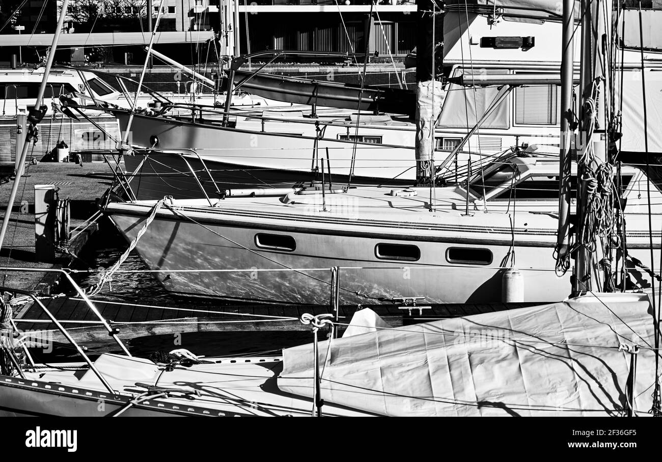 Dicht gepackte Yachten und Segelboote an der Anlegestelle im Hafen, schwarz-weiß Stockfoto