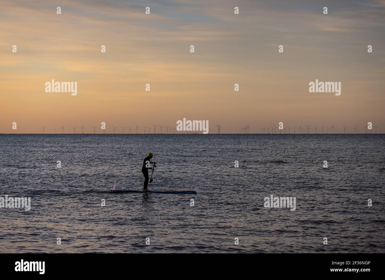 Ein Mitglied des öffentlichen Paddelboarding im Meer in Brighton, East Sussex Stockfoto