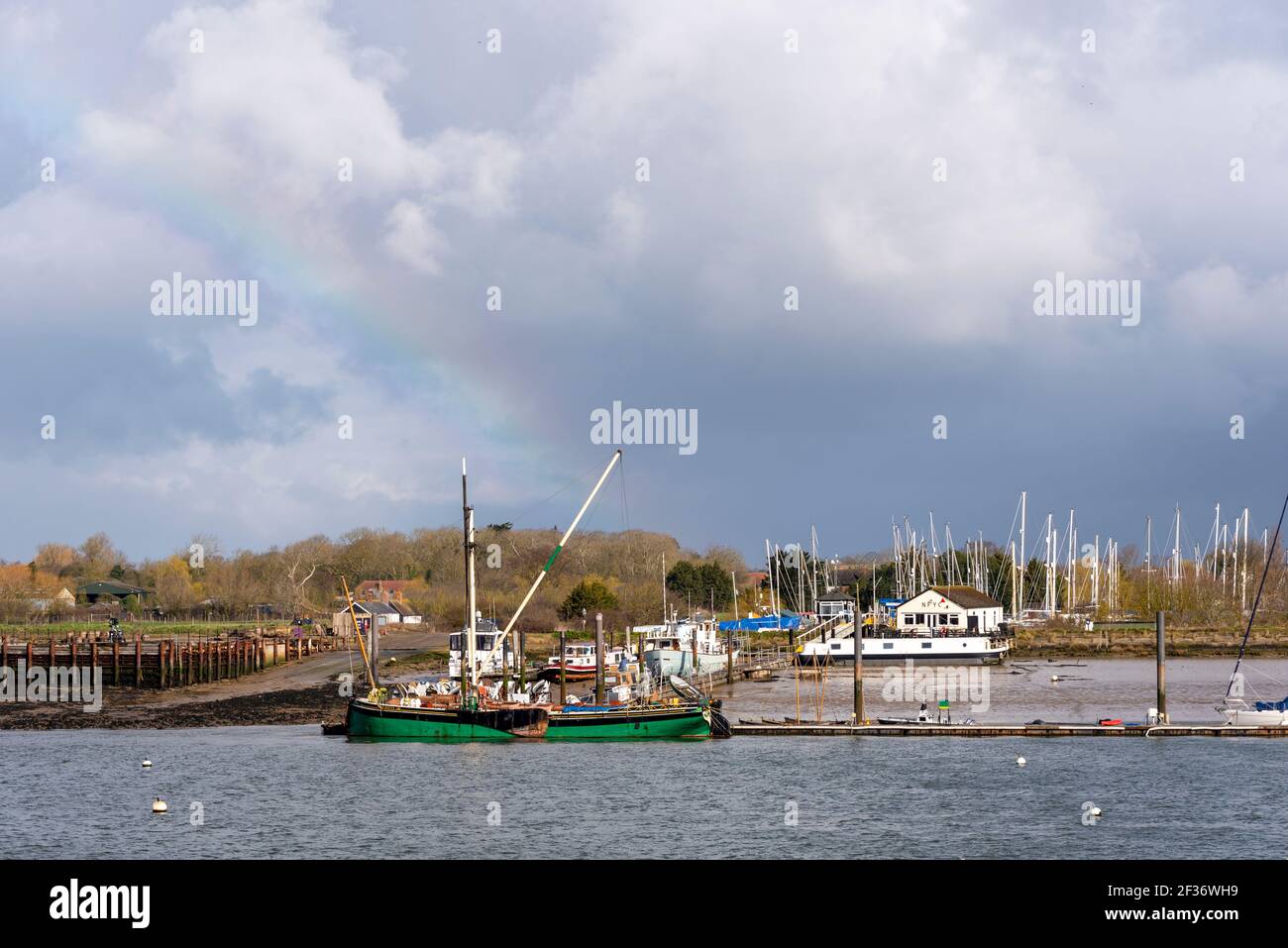 Flussufer, Bootsliegeplätze und Kai von North Fambridge auf dem Fluss Crouch, Blick von South Fambridge, Rochford, Essex, Großbritannien Stockfoto