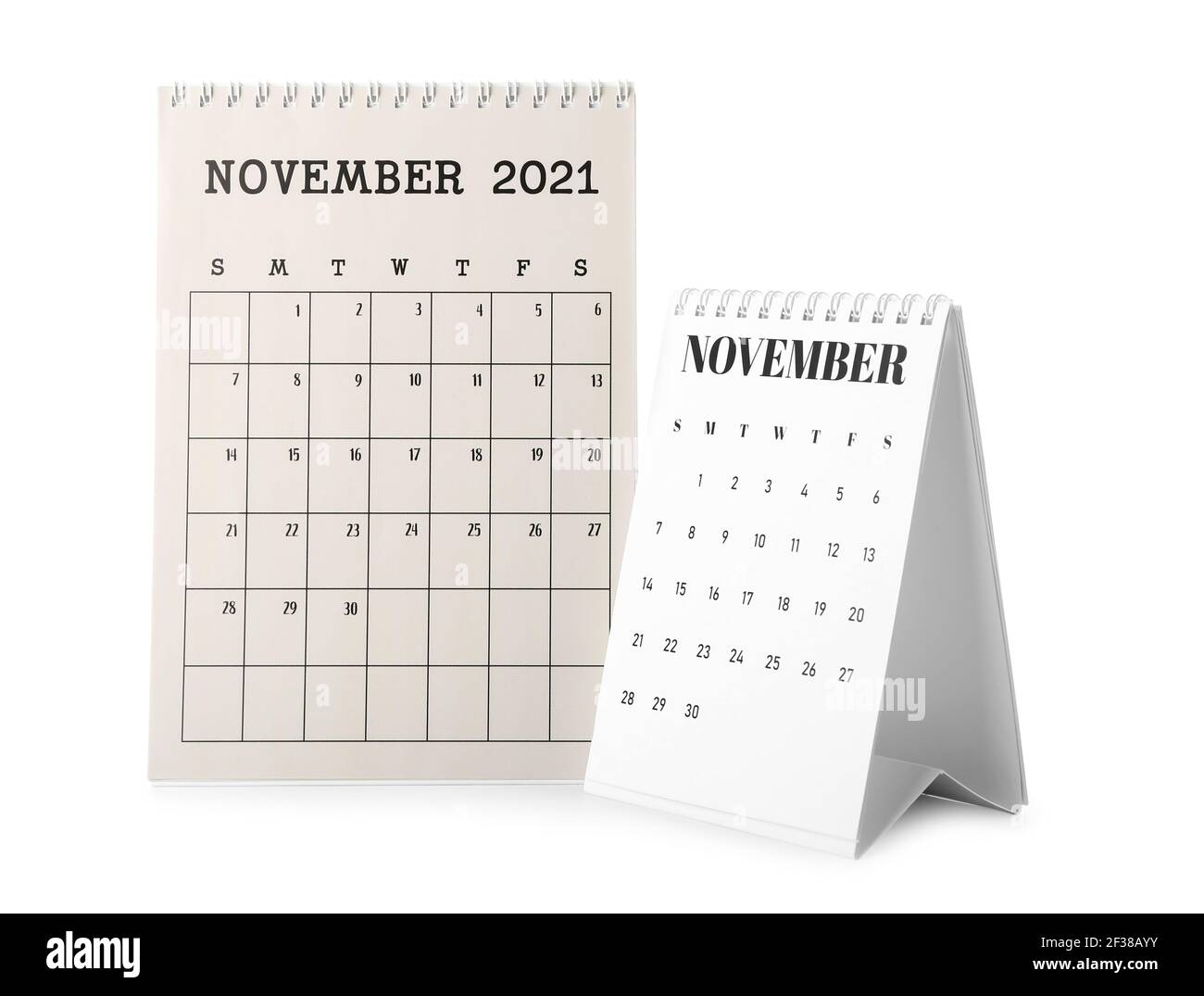 Papierkalender auf weißem Hintergrund drehen Stockfoto