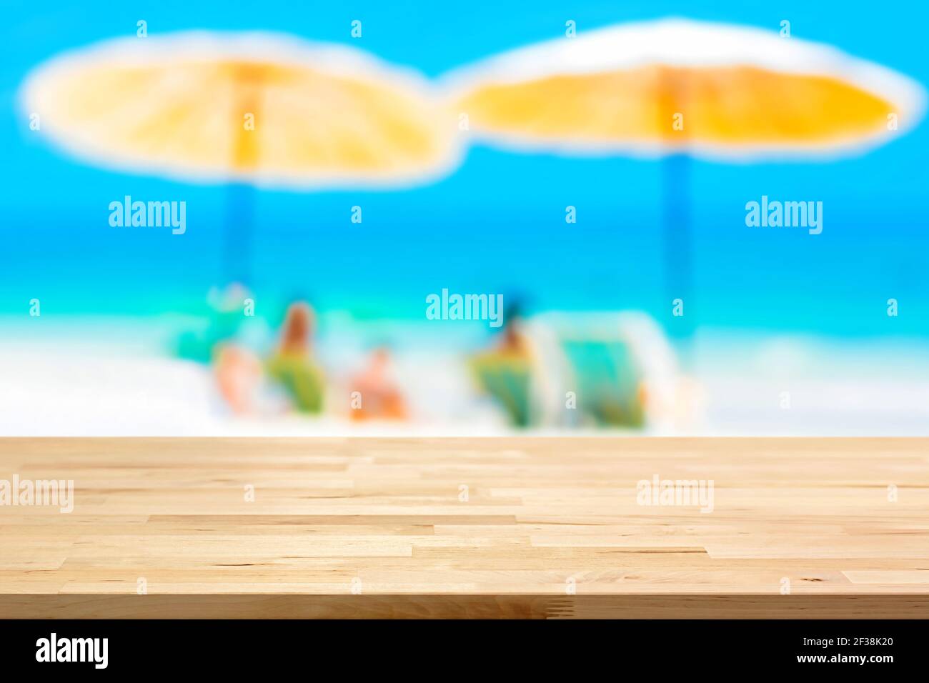 Holztischplatte auf verschwommenem Strand Hintergrund, Sommerurlaub Hintergrund Konzept - kann für Montage verwendet werden oder zeigen Sie Ihre Produkte Stockfoto