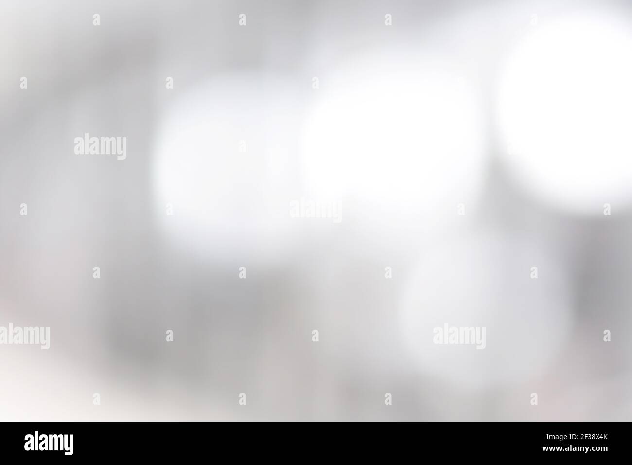 Verschwommener weißer Bokeh abstrakter Hintergrund Stockfoto