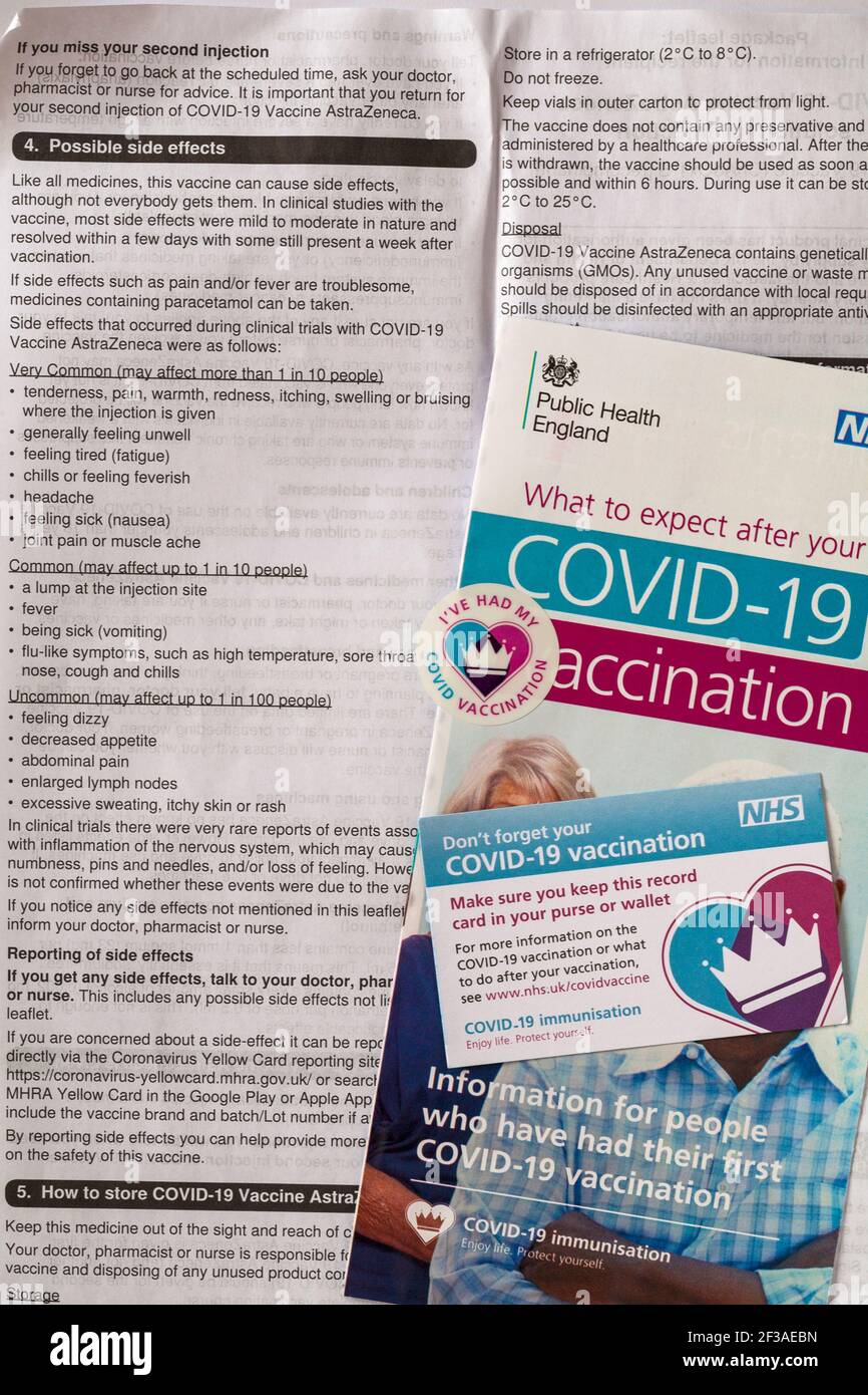 Was Sie nach Ihrem Covid-19 Impfhinweis erwarten können NHS mit AstraZeneca-Impfstoffinformationsblatt mit einer Auflistung möglicher Nebenwirkungen Stockfoto