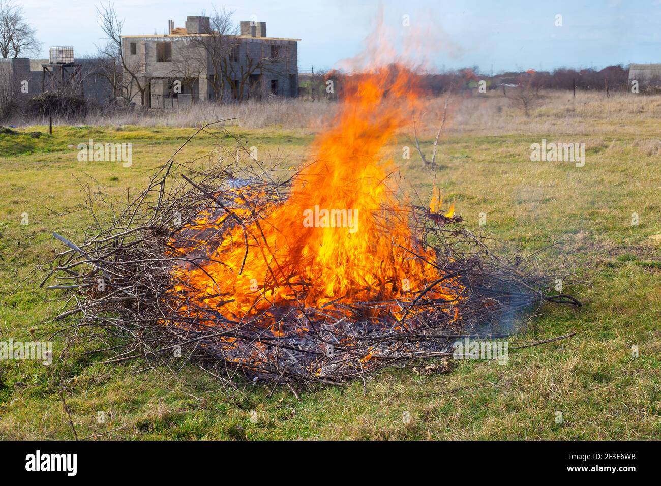 Lagerfeuer im Sommerhaus. Brennende trockene Äste auf dem Feld, Müllentsorgung. Brandgefahr. Stockfoto