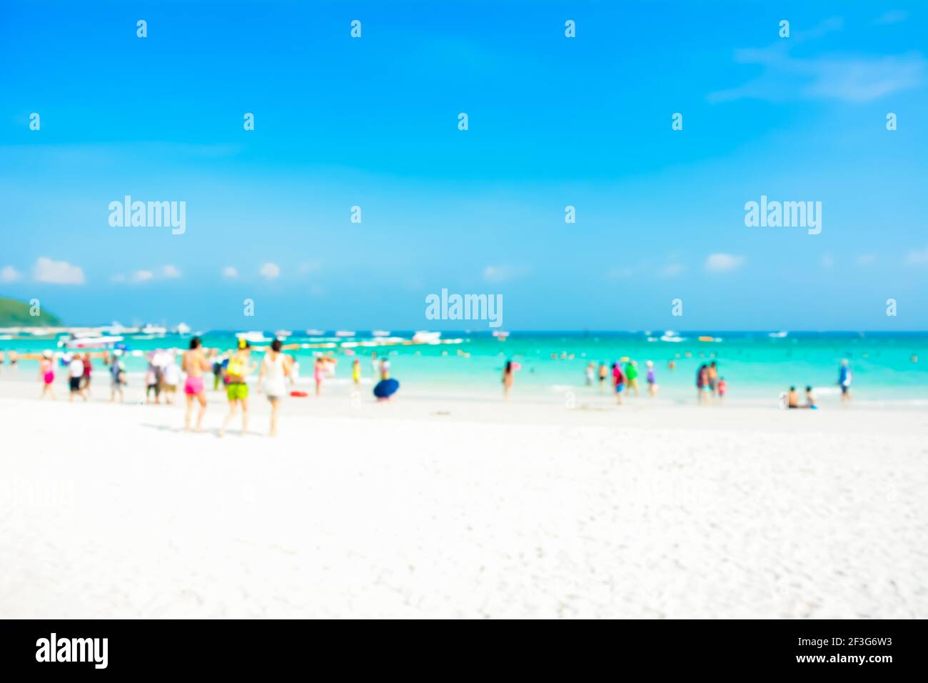 Verschwommene Menschen am weißen Sandstrand mit blauen Meer ein Himmelshintergrund Stockfoto