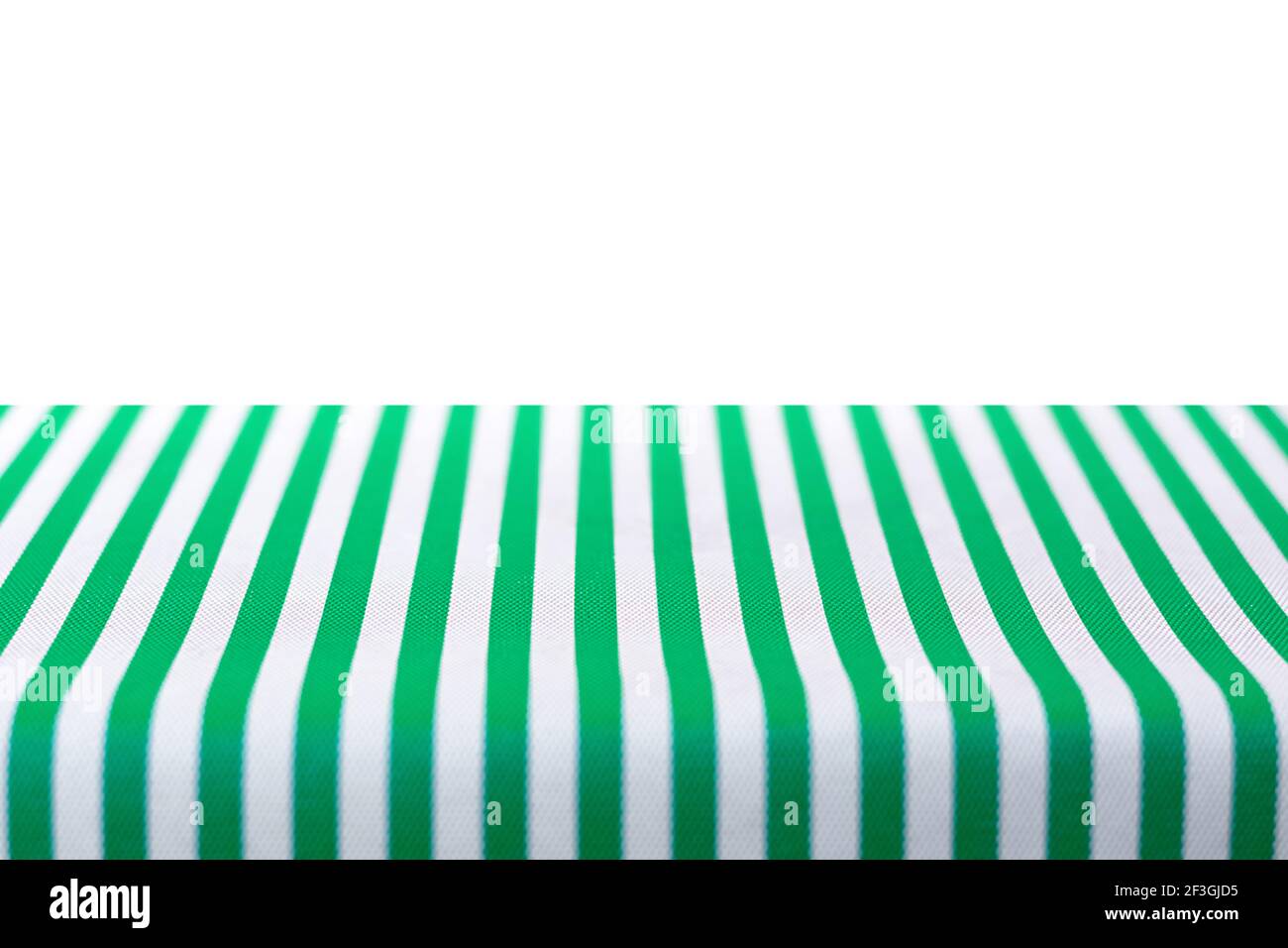 Tischplatte mit grün und weiß gestreiften Tischdecken bedeckt Stockfoto