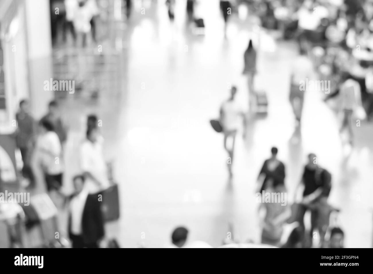Verschwommene Personen auf dem Flughafenflur in schwarz-weiß, können als Hintergrund verwendet werden Stockfoto