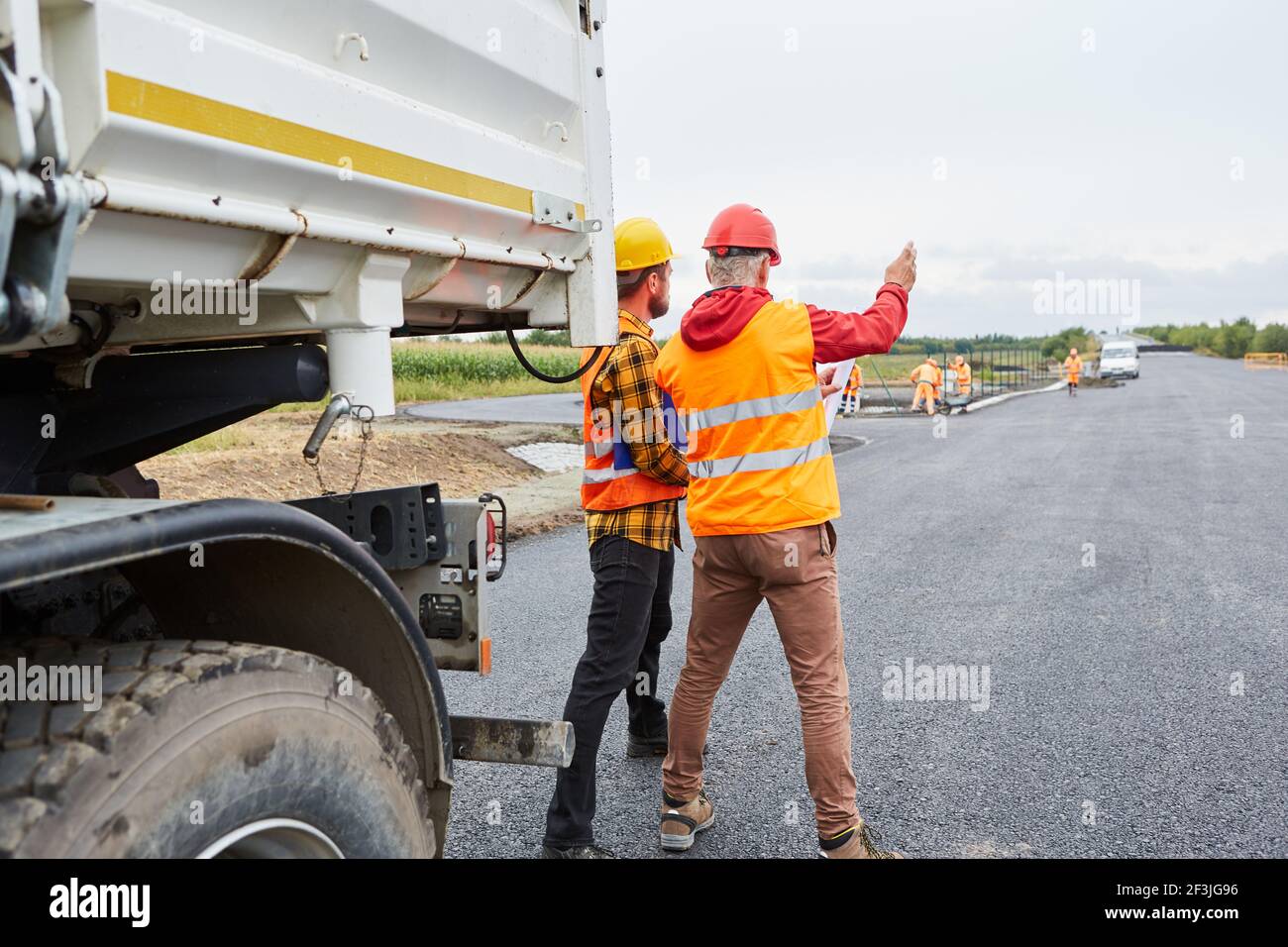 Vorarbeiter und Architekt mit Baustellenplan auf Baustellenplan Entwicklung im neuen Gebäudebereich Stockfoto
