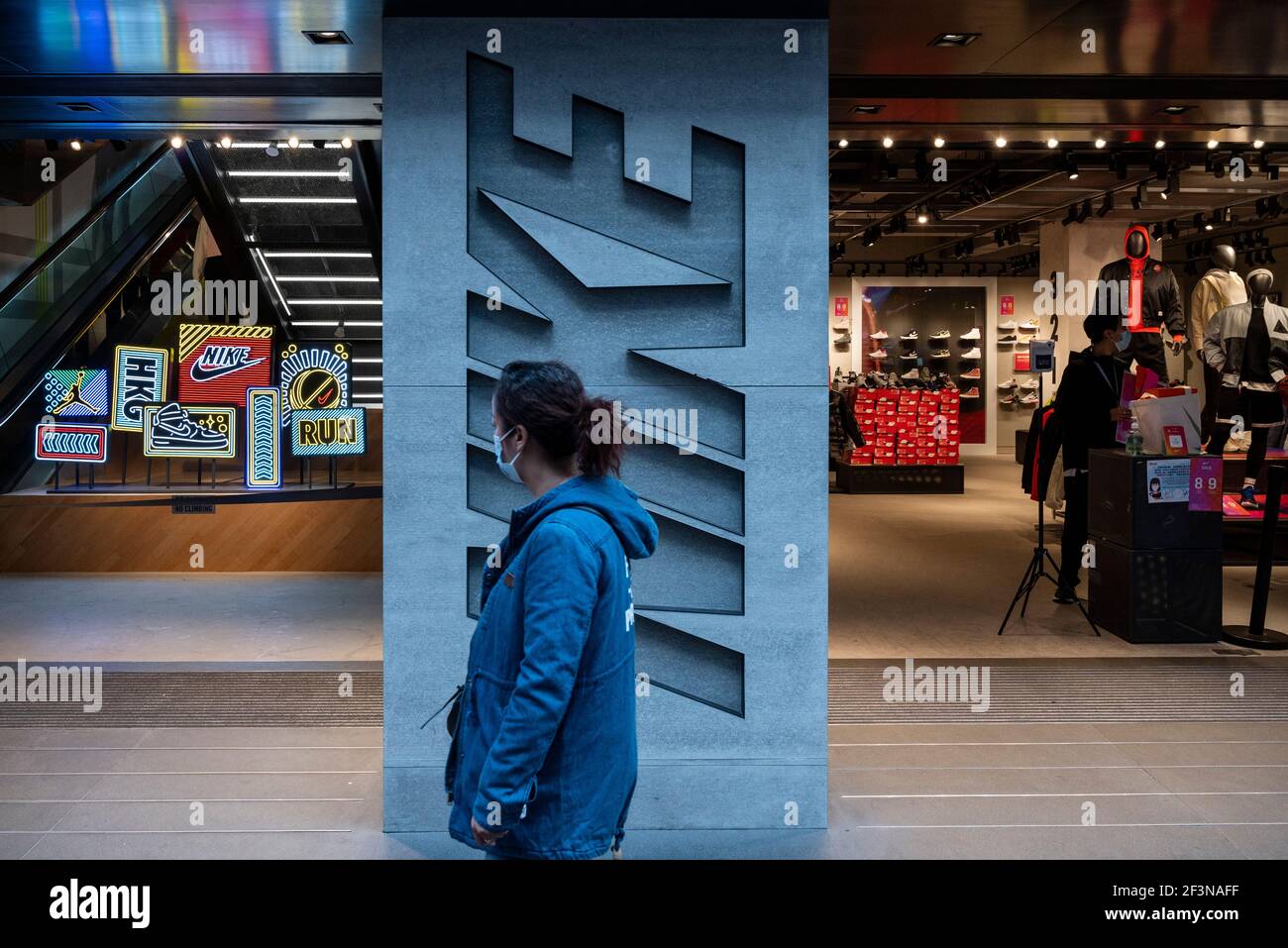 Hongkong, China. März 2021, 17th. Ein Fußgänger geht an der amerikanischen multinationalen Sportbekleidungsmarke, dem Nike Store und seinem Logo in Hongkong vorbei. (Foto von Budrul Chukrut/SOPA Images/Sipa USA) Quelle: SIPA USA/Alamy Live News Stockfoto