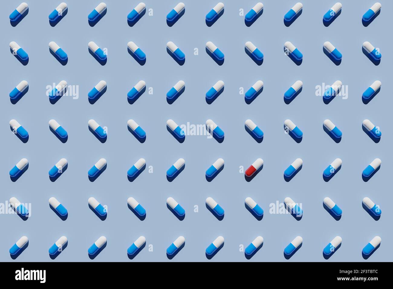 Rote und weiße Kapsel, die von blauen und weißen Kapseln auf blauem Hintergrund umgeben ist. 3D Rendern Stockfoto