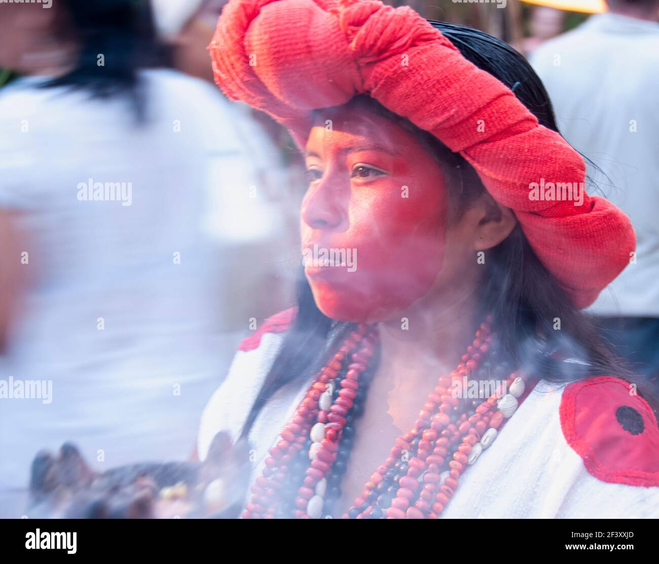 Porträt eines jungen Maya-Mädchen mit Make-up auf sie Gesicht und ein Brazier mit kopischen Rauch während einer beleuchtet Ritualzeremonie der Vorfahren in Mexiko Stockfoto