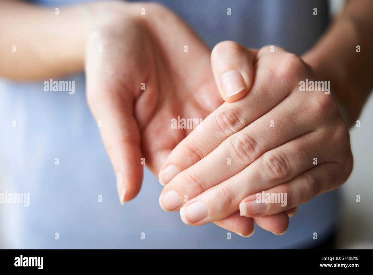 Nahaufnahme einer Frau, die mit Desinfektionsmittel die Hände reibt Stockfoto