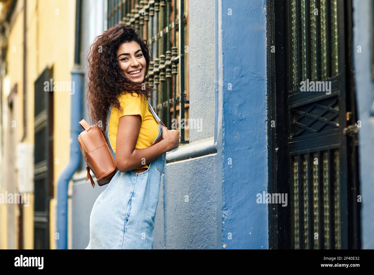 Junge afrikanische Frau, Modell der Mode, mit schwarzen curly Frisur im Freien. Lächelnd arabischen Mädchen in Freizeitkleidung in Urban Street. Stockfoto