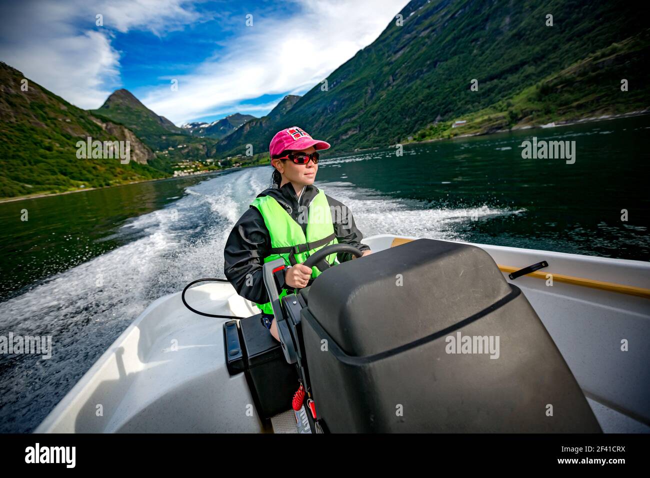 Frau, die ein Motorboot. Geiranger Fjord, schöne Natur Norwegen. Sommer Urlaub. Geiranger Fjord, einem UNESCO-Weltkulturerbe. Stockfoto