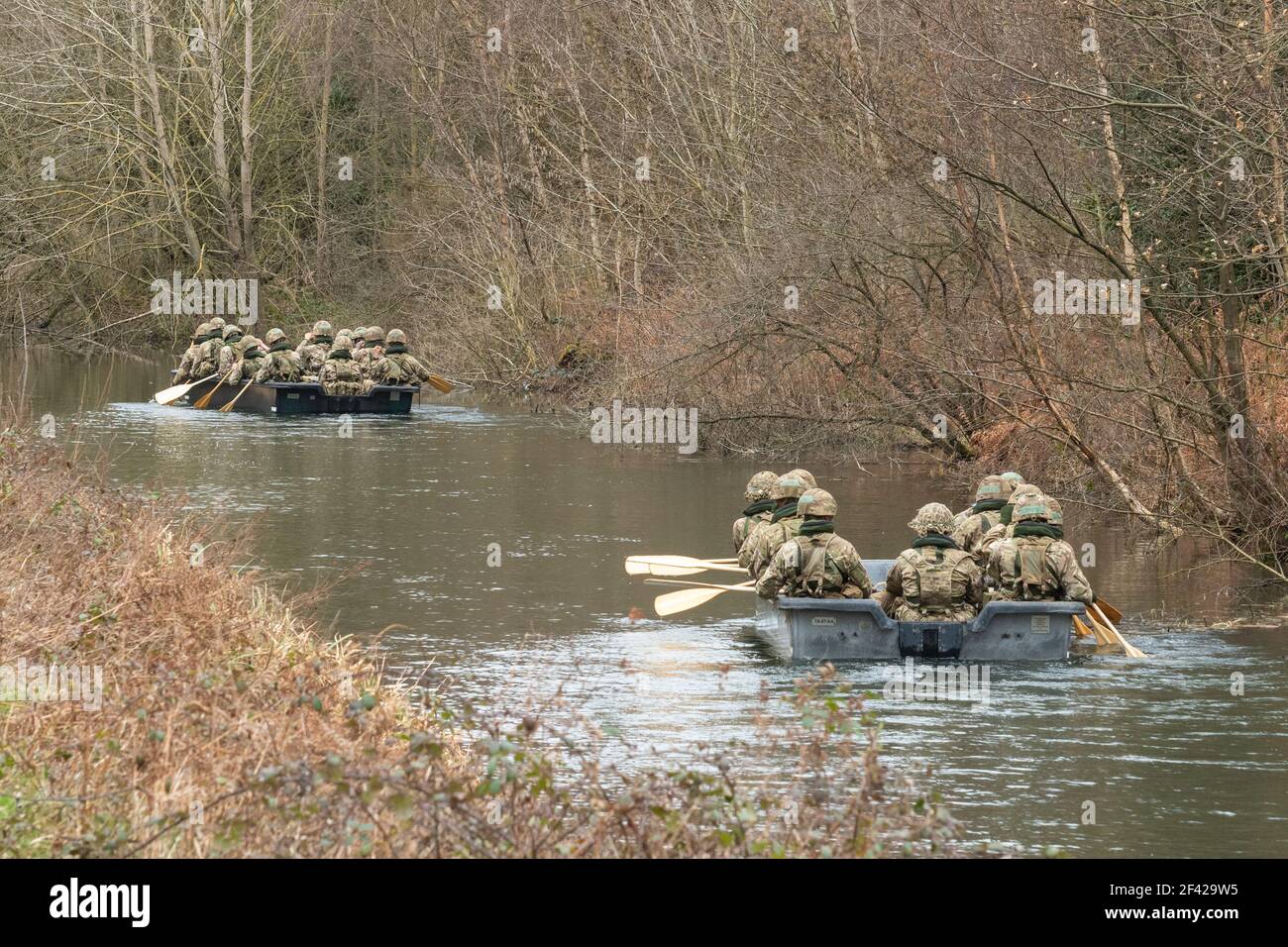 Britische Armee auf einer militärischen Trainingsübung in Ruderbooten auf einem Kanal, Hampshire, Großbritannien Stockfoto