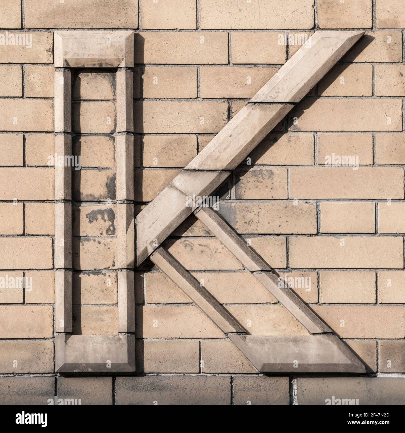 Großbuchstabe K, bestehend aus hellem Klinker Stockfoto