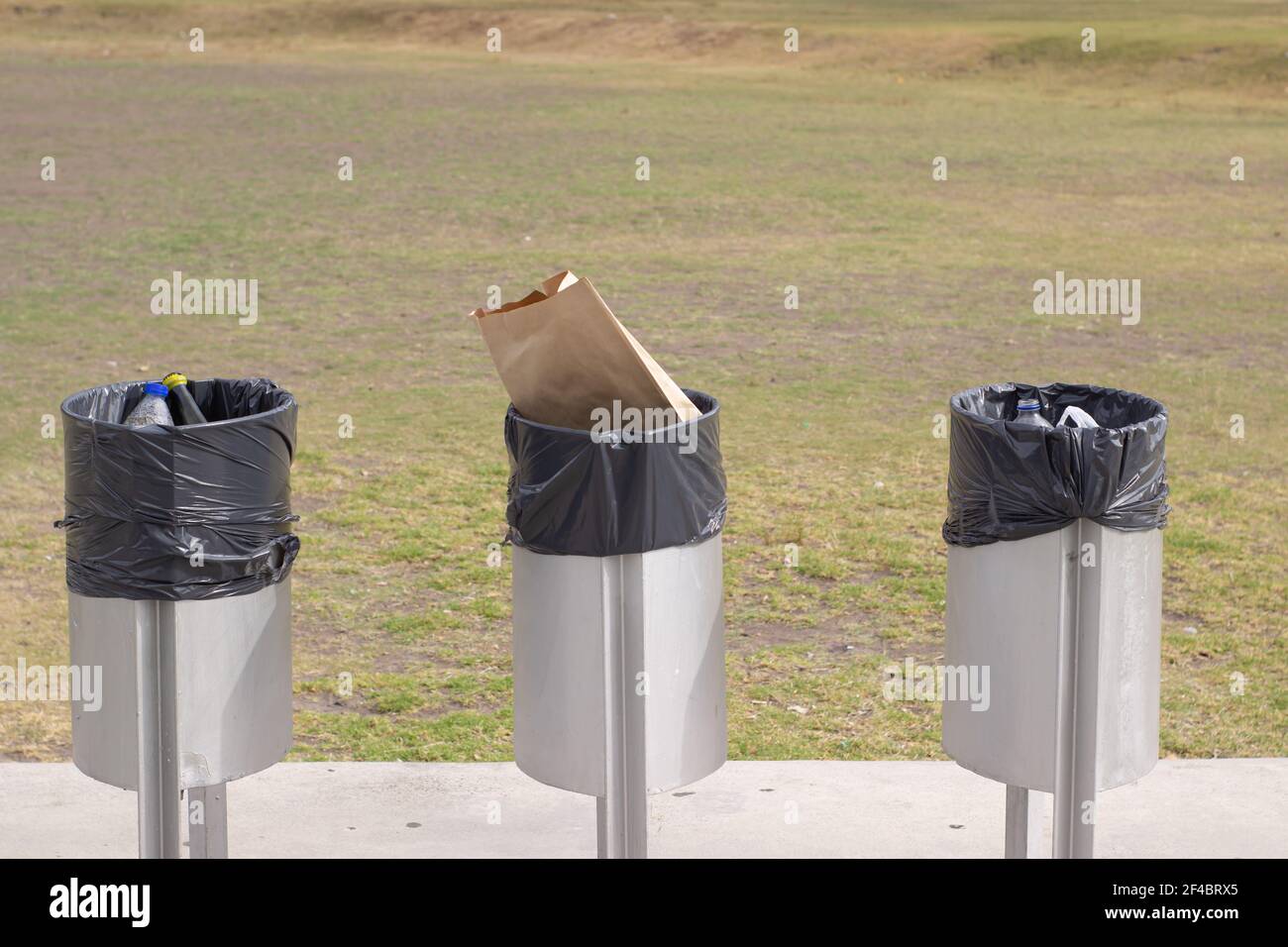 Drei Mülleimer im Stadtpark. Stockfoto